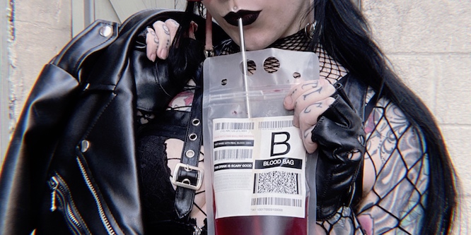 Vampire drinking blood bag